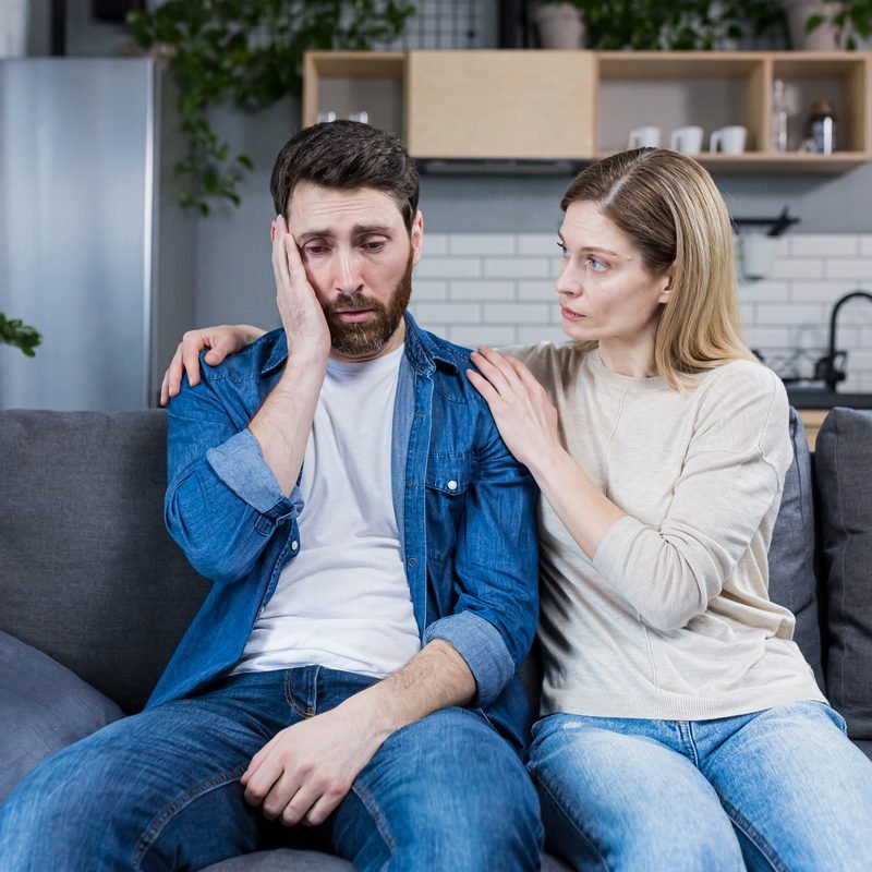 Family conflict. Young couple, family, man and woman on a reception at the psychologist. Sit on the couch, talk, gesture. discuss, argue.